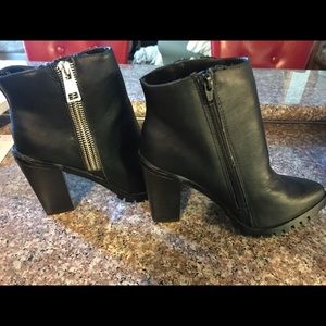 Black zip up ankle boots with silver zipper detail